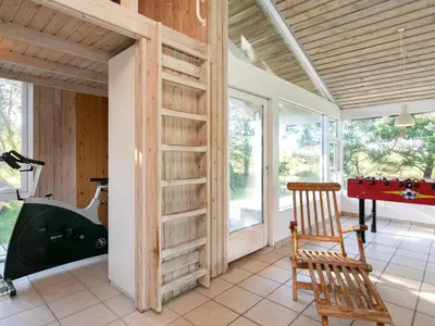 a room with a desk and a table and a chair at Charming Beach Retreat - By Traum Ferienwohnungen in Fjerritslev