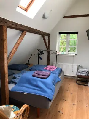 a bedroom with two beds in a attic at BrusaaUdlejning in Nibe