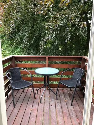 a table and two chairs on a deck at BrusaaUdlejning in Nibe