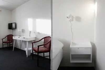 a bedroom with a desk and a bed with a chair at Roslev Hus in Roslev