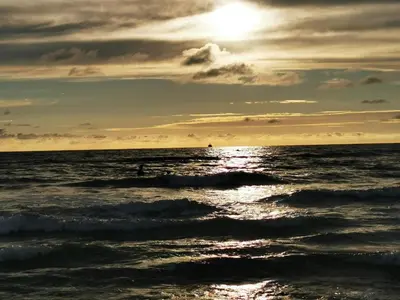 a sun setting over the ocean with waves at Luxury Retreat in Gronhoj-By Traum in Løkken