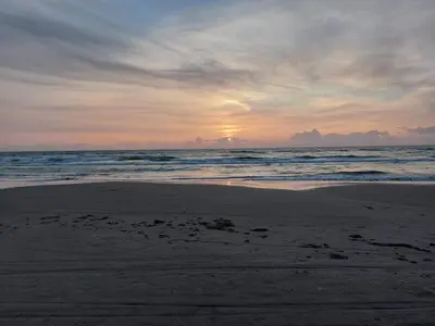 a sunset on a beach with the ocean at Luxury Retreat in Gronhoj-By Traum in Løkken