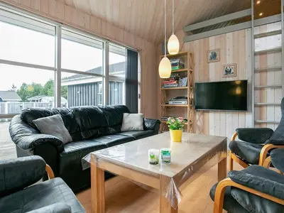 a living room with a couch and a table at Luxury Retreat in Gronhoj-By Traum in Løkken