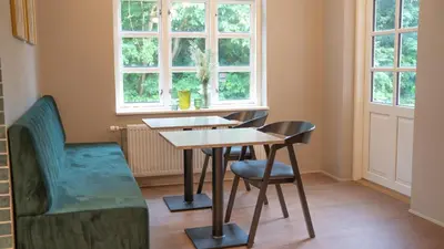 a table and chairs in a room with a window at Hotelcity in Holstebro