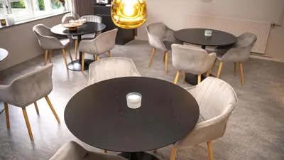 a table and chairs with a cup on top of it at Hotelcity in Holstebro