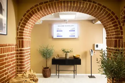 an archway in a room with a table and plants at Hotelcity in Holstebro