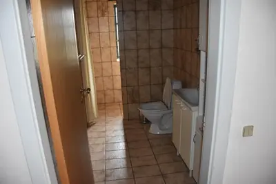 a small bathroom with a toilet and a sink at Sommerhus Farmen i Hanstholm in Hanstholm