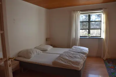 a bedroom with two beds and a window at Sommerhus Farmen i Hanstholm in Hanstholm