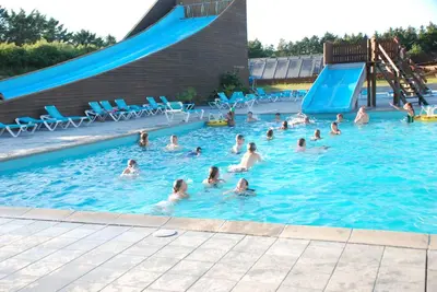 a group of people swimming in a swimming pool at Sommerhus Farmen i Hanstholm in Hanstholm