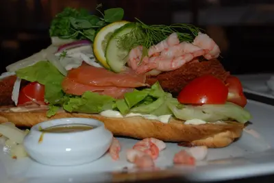 a sandwich with shrimp and vegetables on a plate at Sommerhus Farmen i Hanstholm in Hanstholm