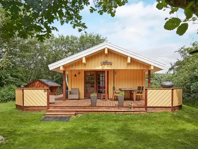a house with a deck with a grill at Cozy Coastal Cottage Retreat-By Traum in Sindrup