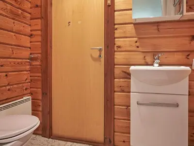 a bathroom with a toilet and a sink at Cozy Coastal Cottage Retreat-By Traum in Sindrup