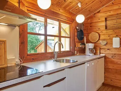 a kitchen with a sink and a window in a cabin at Cozy Coastal Cottage Retreat-By Traum in Sindrup