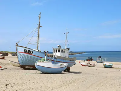 a group of boats sitting on the beach at Bright Coastal Retreat in Vorupor-By Traum in Thisted