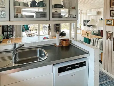 a kitchen with a sink and a counter top at 6 person holiday home in Løkken in Løkken