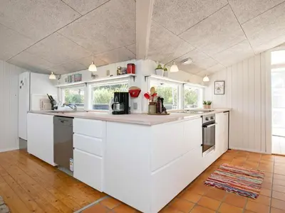 a kitchen with white cabinets and a counter top at 8 person holiday home in Blokhus in Blokhus