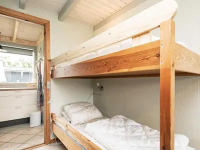 a bunk bed in a room with a bunk bed in a house at 6 person holiday home in Roslev in Roslev