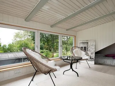 a room with two chairs and a table and windows at 6 person holiday home in Roslev in Roslev