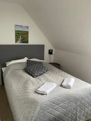a bedroom with a bed with two towels on it at Hilmor's Lejligheder in Viborg