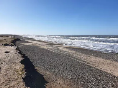an empty beach with the ocean in the background at 6 person holiday home in Brovst in Brovst