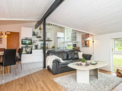 a living room with a couch and a table at 6 person holiday home in Brovst in Brovst