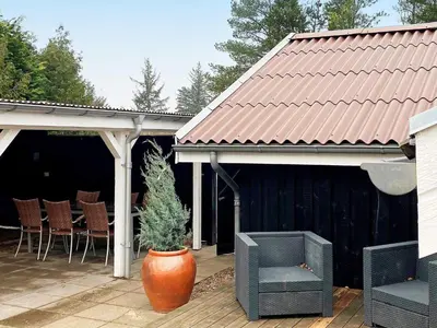 a patio with a pot with a plant in it at 6 person holiday home in Brovst in Brovst