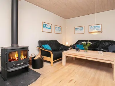 a living room with a couch and a stove at 6 person holiday home in Fjerritslev in Fjerritslev