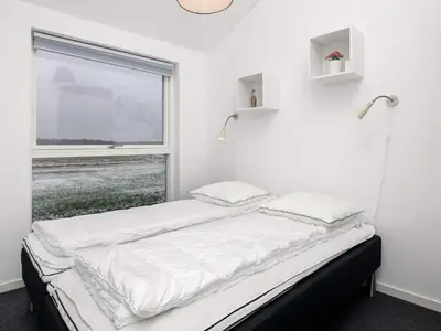 a bed in a room with a window at 6 person holiday home in Løkken in Løkken