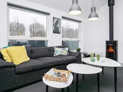 a living room with a couch and two tables at 6 person holiday home in Løkken in Løkken