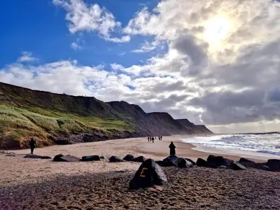 a group of people standing on a beach at Family Holiday Home by North Sea in Lemvig