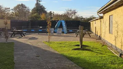 a park with picnic tables and a playground at Bygholm Camping og aktiviteter in Vesløs