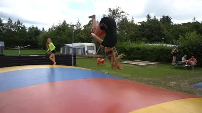 a person jumping on top of a trampoline at Bygholm Camping og aktiviteter in Vesløs