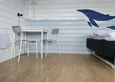 a room with a table and two chairs and a bed at Bygholm Camping og aktiviteter in Vesløs