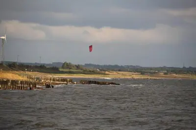 a kite flying over a body of water at Beautiful and amazing view - 3 bedroom cottage in Vinderup
