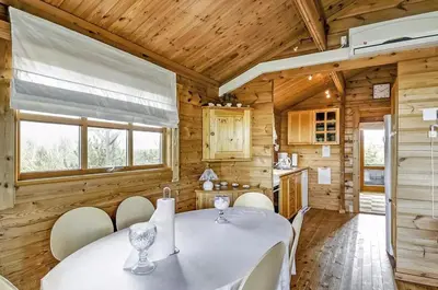 a dining room with a white table and chairs at Cozy house with stunning sea views in Pandrup