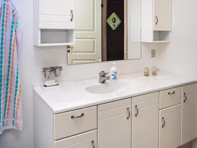 a bathroom with a white sink and a mirror at 6 person holiday home in Hurup Thy in Sønder Ydby