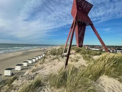 a sculpture on a beach next to the ocean at 6 person holiday home in Blokhus in Blokhus
