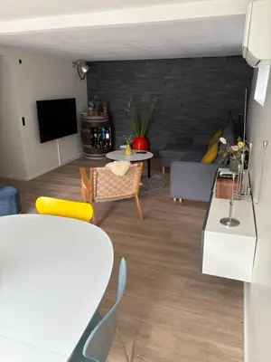 a living room with a couch and a table at Nyistandsat højloftet kælderlejlighed på 70 m2 i Viborg centrum, med plads til 4 personer in Viborg
