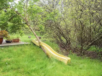 a slide in the middle of a field with trees at Secluded Retreat by Limfjorden - By Traum Ferienwohnungen in Sindrup