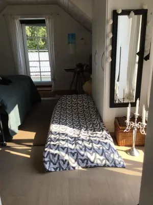 a bedroom with a bed and a large window at Vejlen Bed & Kitchen in Vadum