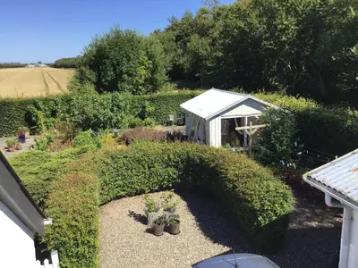 an overhead view of a garden with a small greenhouse at Vejlen Bed & Kitchen in Vadum