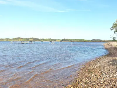 a beach with a dock in the water at 6 person holiday home in Højslev-By Traum in Højslev