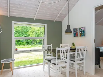 a dining room with a table and chairs and a window at 6 person holiday home in Højslev-By Traum in Højslev