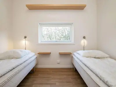 two beds in a room with a window at 6 person holiday home in Vestervig-By Traum in Vestervig