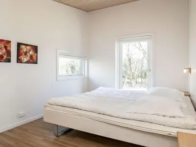 a white bedroom with a bed and a window at 6 person holiday home in Vestervig-By Traum in Vestervig