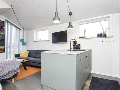 a kitchen and living room with a sink and a couch at 10 person holiday home in Harboøre-By Traum in Harboør