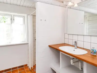 a bathroom with a sink and a window at 10 person holiday home in Thisted in Thisted