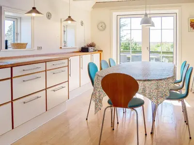 a kitchen with a dining table and chairs at 10 person holiday home in Thisted in Thisted