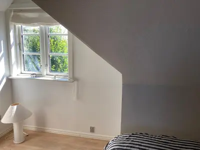 a bedroom with a bed and a window at Kallerup Hgård in Thisted