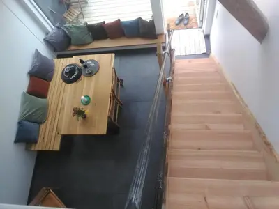 a stairway leading up to a room with a table at Rikke og Franks Svineri in Lemvig